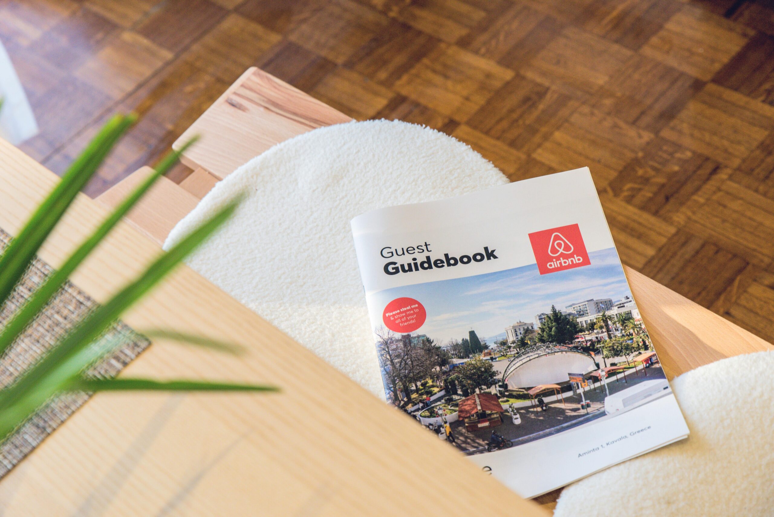 Airbnb Guest Guidebook on a modern table in Kavala, Greece home.